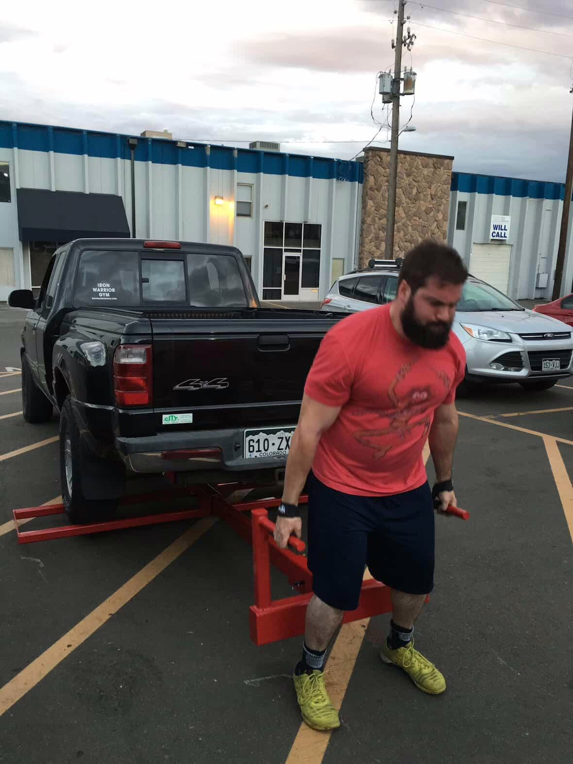 Iron Warrior athlete training a car deadlift