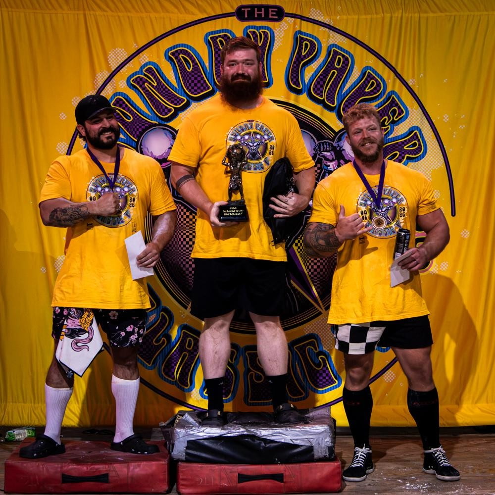 Iron Warrior athletes on a strongman competition podium
