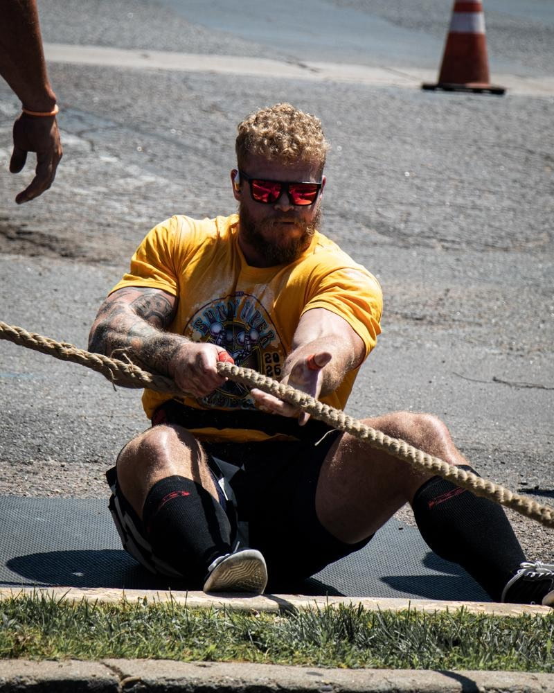 Athlete pulling a rope outdoors