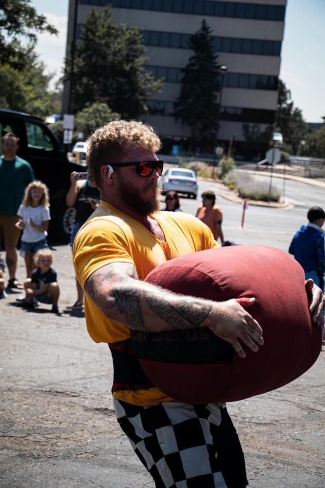 Athlete carrying a heavy sandbag outdoors