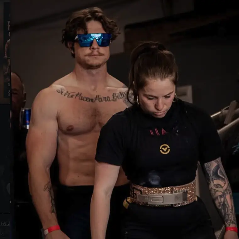 Coach supporting an athlete during a lift at Iron Warrior Gym