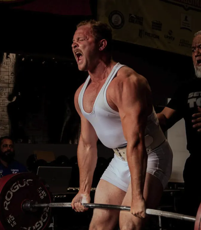 Powerlifter completing a deadlift