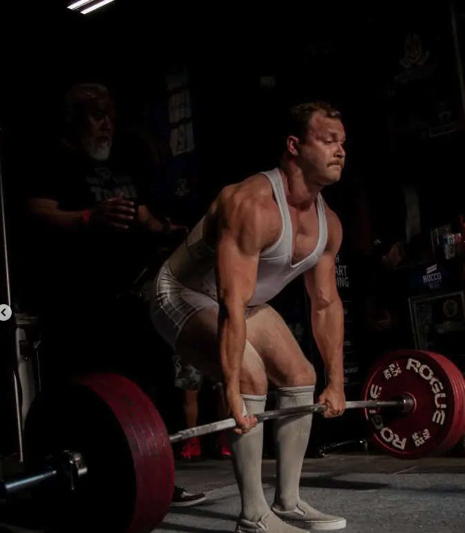 Athlete training with a barbell at Iron Warrior Gym